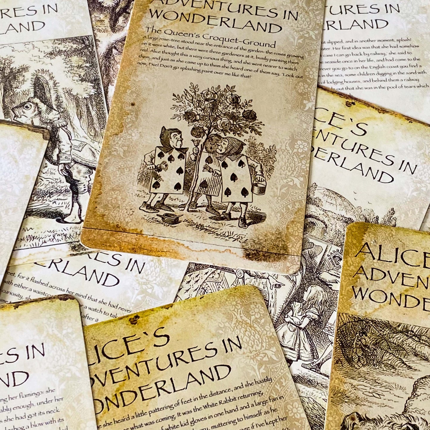 vintage alice in wonderland postcard set with aged sepia parchment illustrations, kraft belly band and wax seal presentation making a beautiful uk letterbox gift