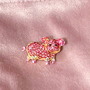 little pink pig sparkly rhinestone pink glittery enamel and gold tone metal brooch on a velvet bag