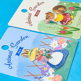 two animal embroidered fabric iron on patches of a squirrel and a rabbit on a blue background