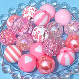 pink and white large 16mm acrylic and wooden beads on a blue background