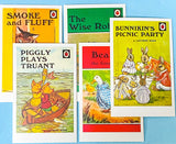 Collection of vintage Ladybird book cover postcards on a blue background with children's stories
