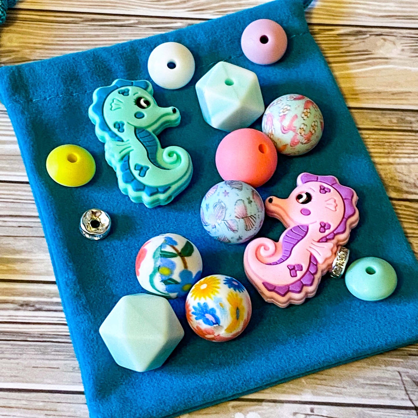 ocean silicone beads set of 15 with seahorse and octopus focal beads and round and multi sided aqua, teal, turquoise, pink and blue beads to make a beaded pen