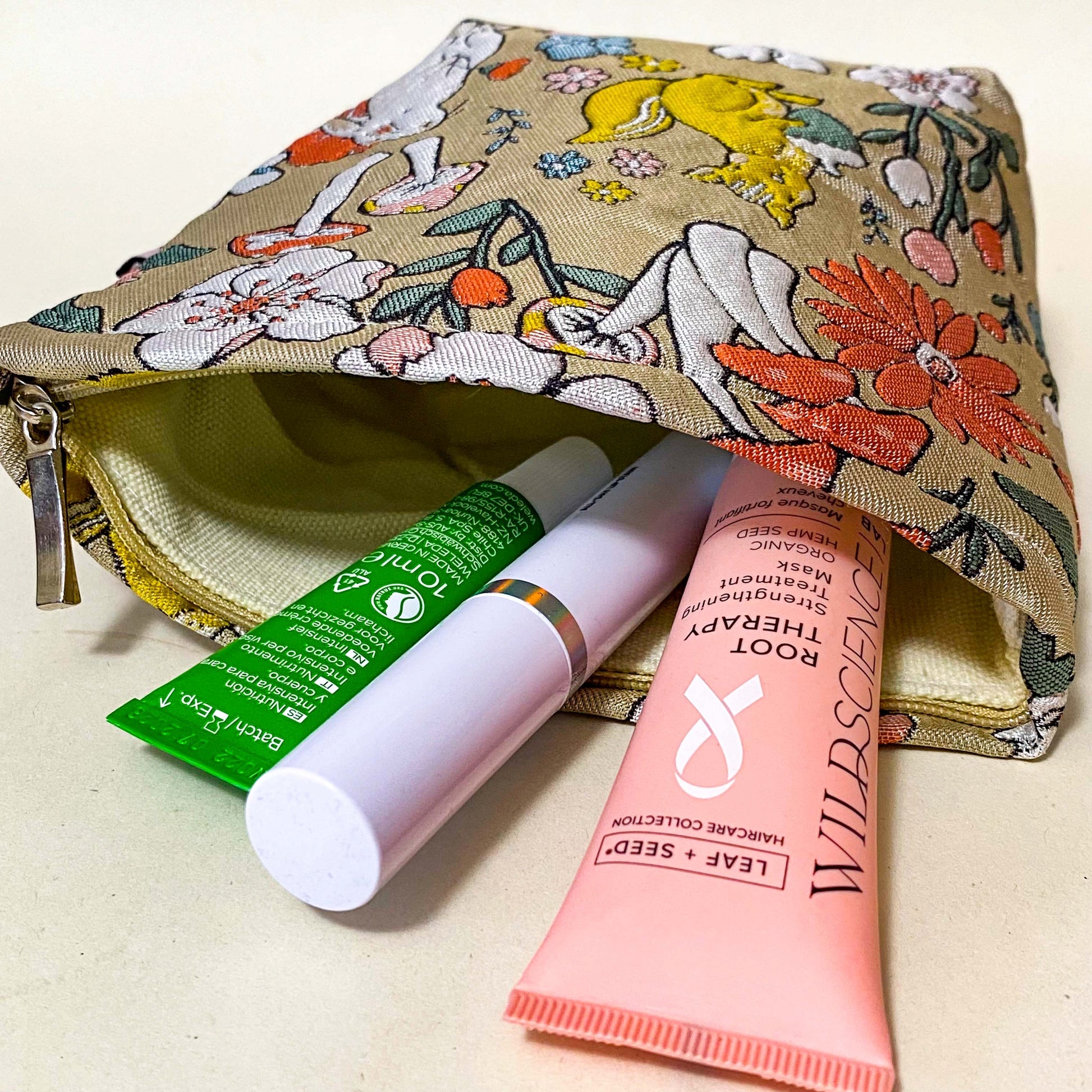 premium woven woodland cosmetic pouch featuring a squirrel, rabbit and wild flowers. Cream lining, bucket shape and concealed zip. Uk premium letterbox gifts. Make up bag or jewellery pouch.