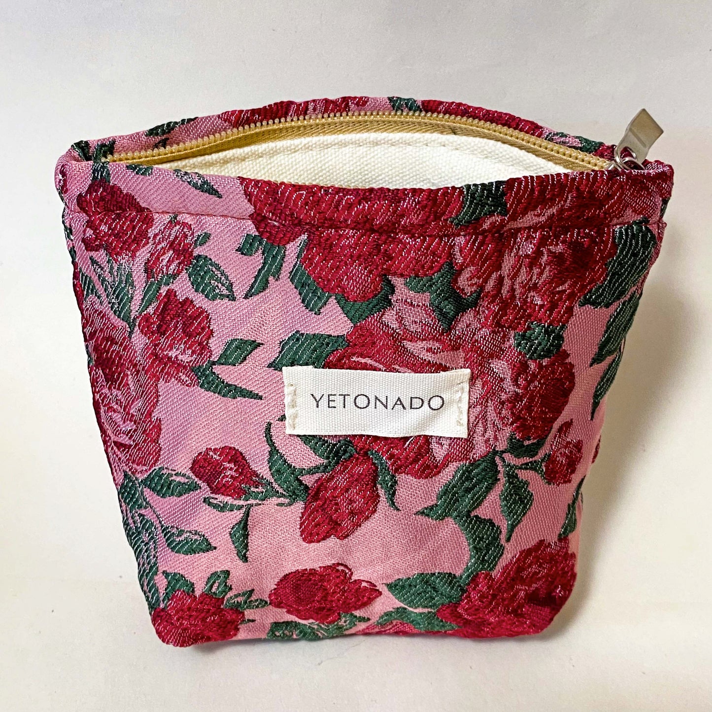 premium woven rose arbour floral cosmetic pouch with crimson roses on a pink background with cream lining and concealed zip. Uk letterbox flower gifts shop.