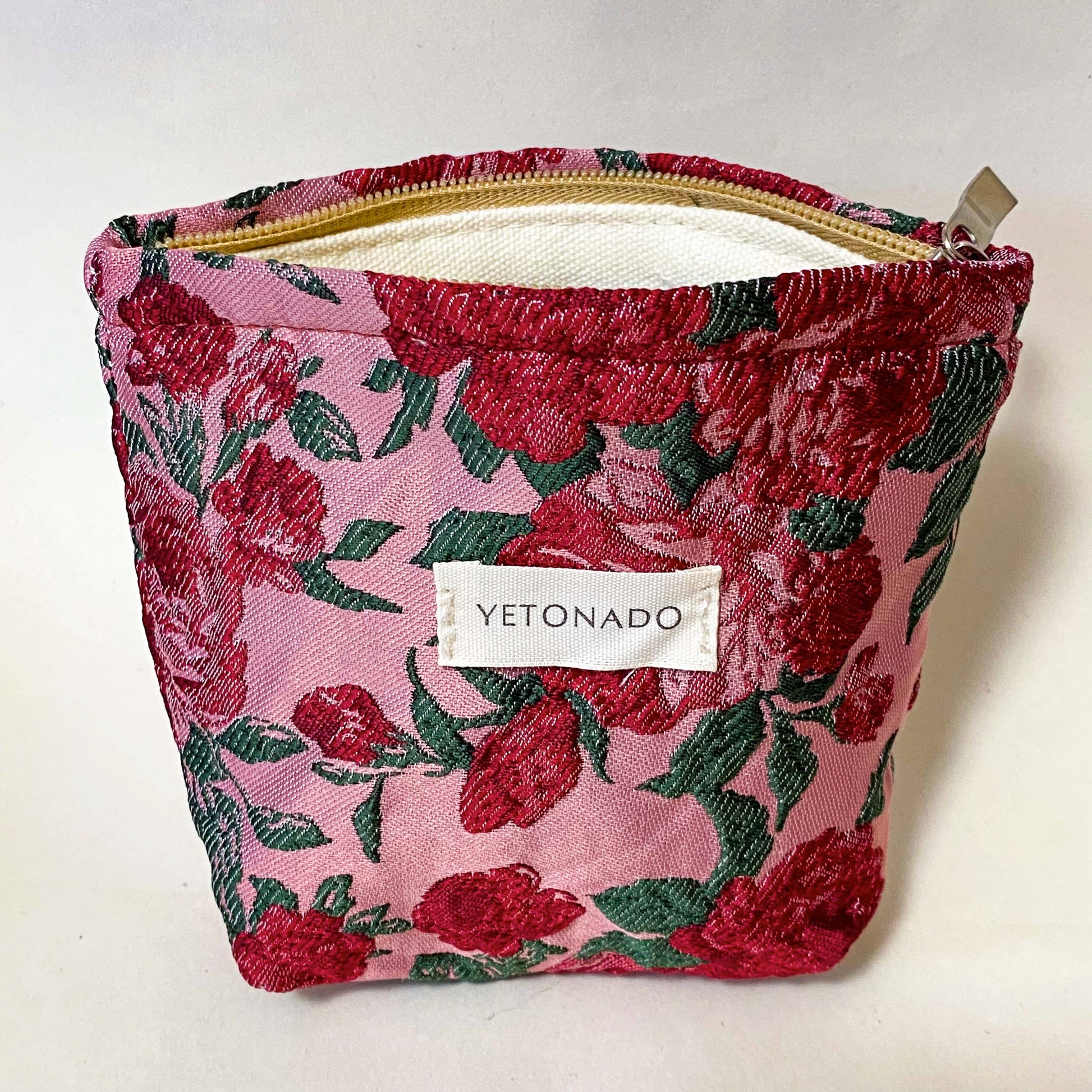premium woven rose arbour floral cosmetic pouch with crimson roses on a pink background with cream lining and concealed zip. Uk letterbox flower gifts shop.