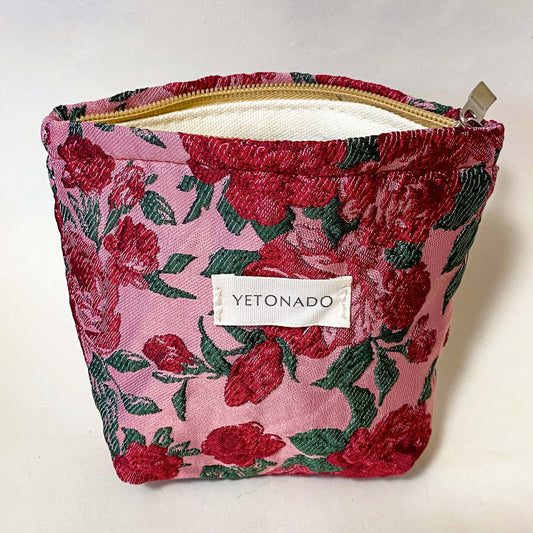 premium woven rose arbour floral cosmetic pouch with crimson roses on a pink background with cream lining and concealed zip. Uk letterbox flower gifts shop.