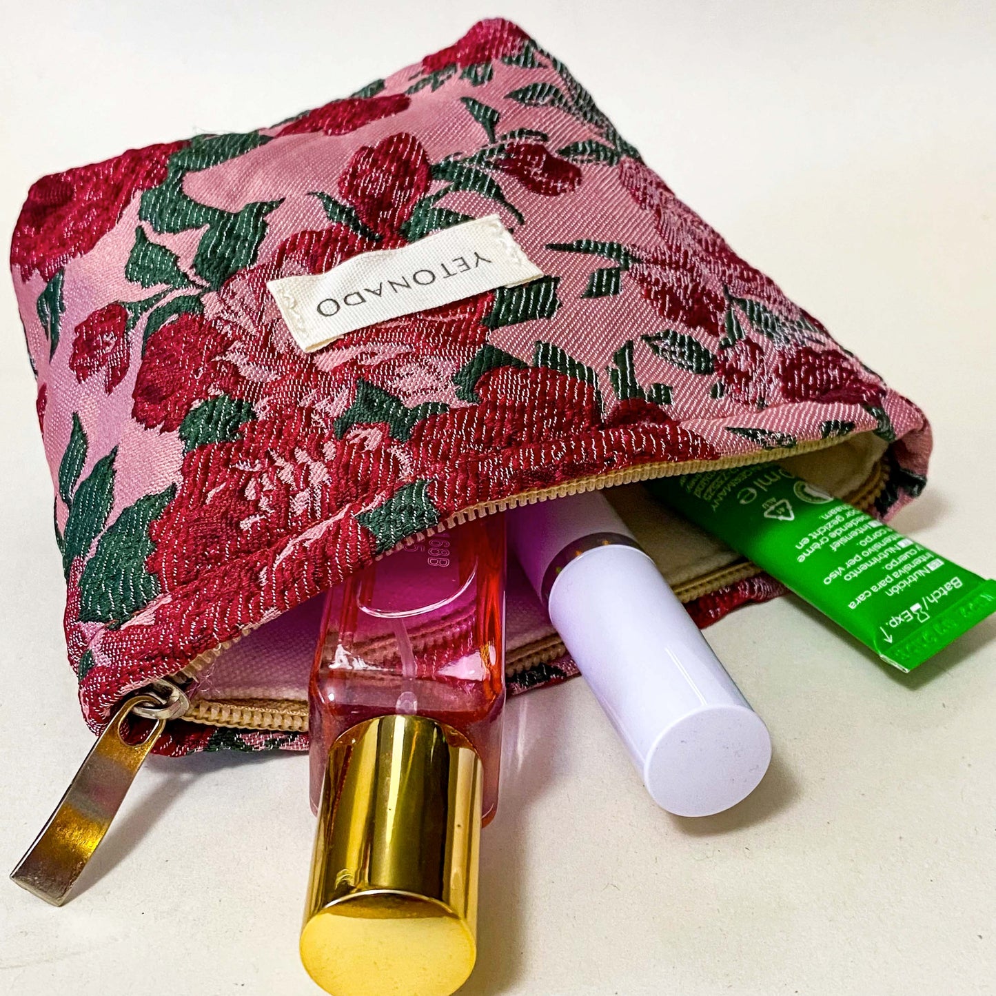 premium woven rose arbour floral bucket shaped small cosmetic pouch with crimson roses on a pink background with cream lining and concealed zip. Uk letterbox flower gifts shop.