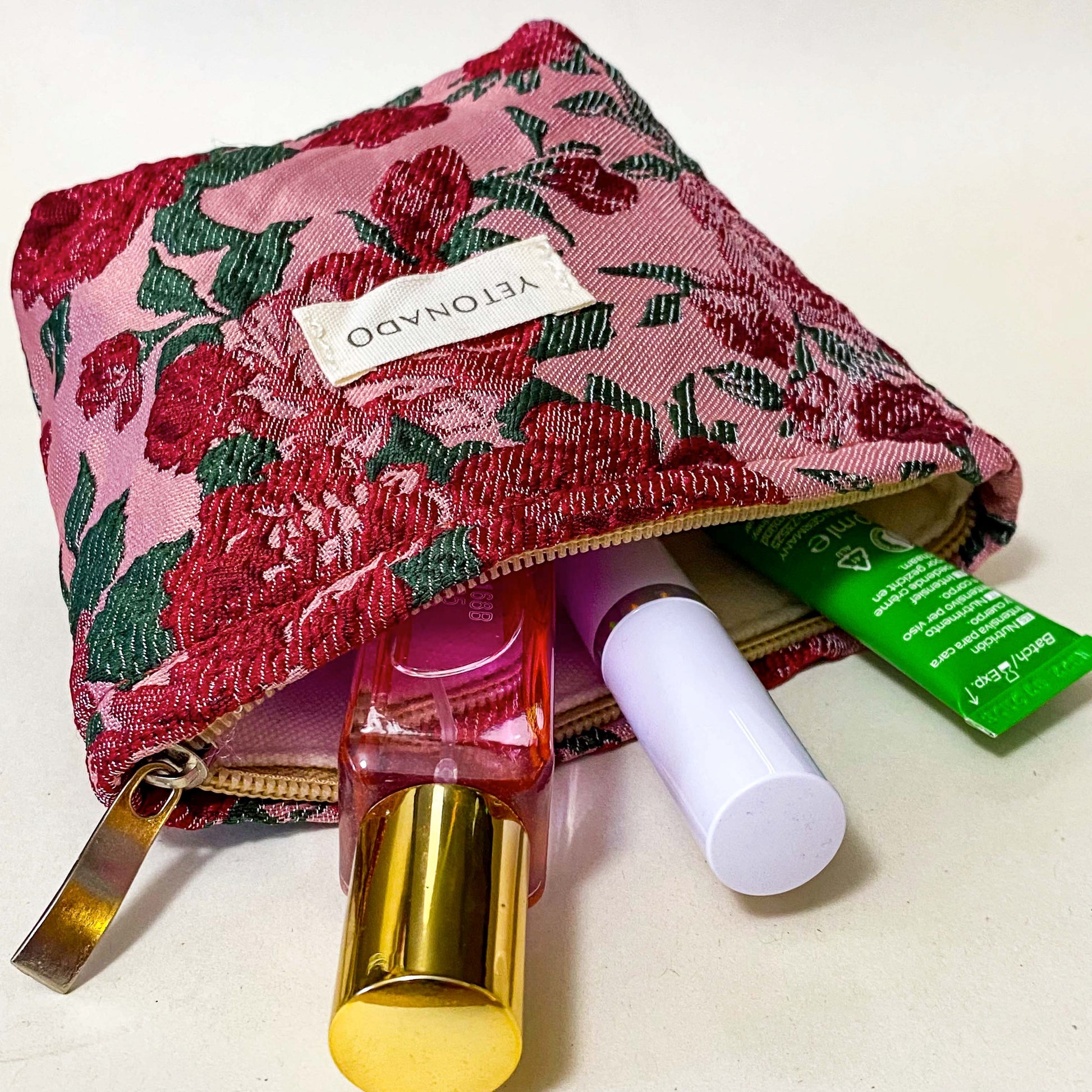 premium woven rose arbour floral bucket shaped small cosmetic pouch with crimson roses on a pink background with cream lining and concealed zip. Uk letterbox flower gifts shop.