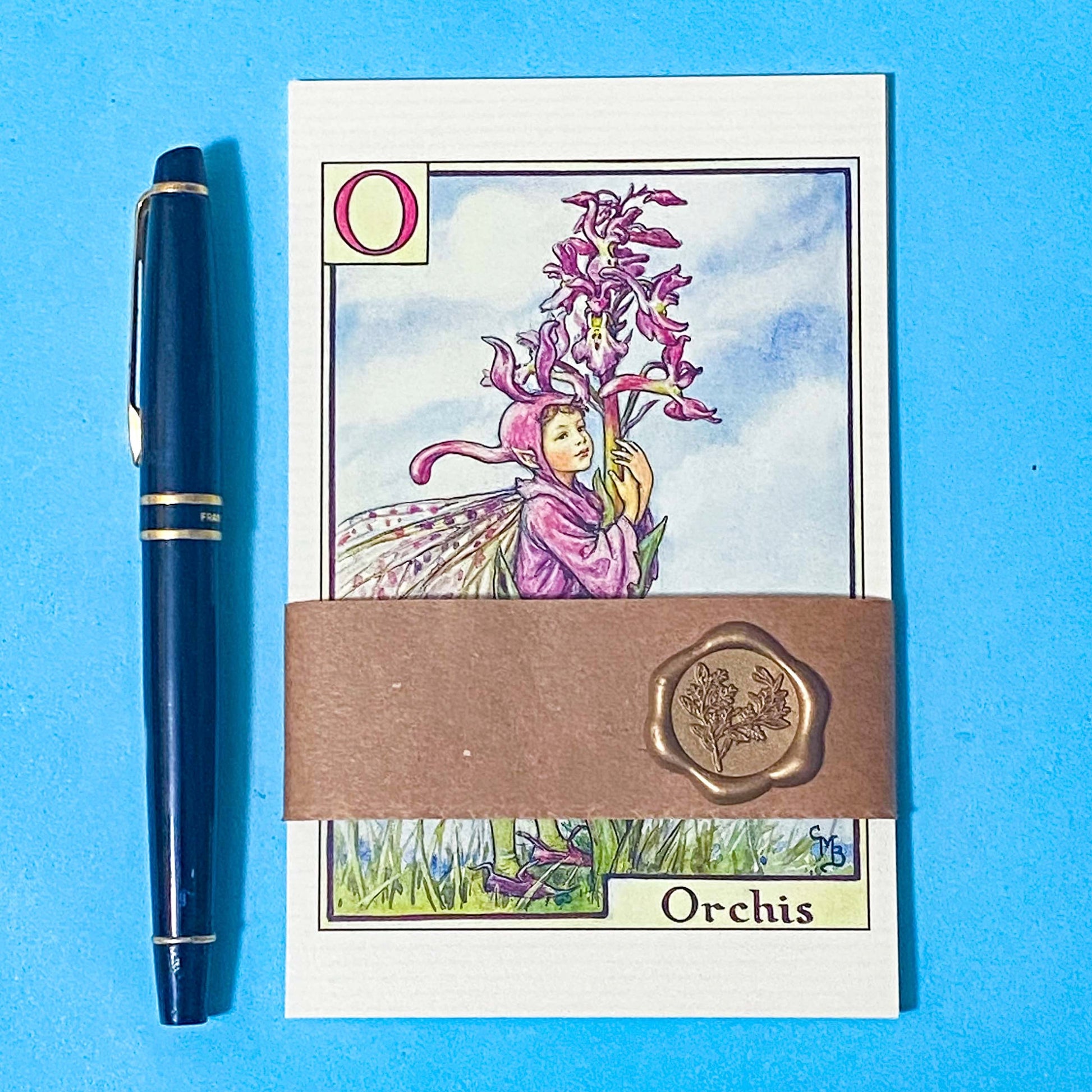 vintage flower fairies postcard set wrapped in a kraft belly band with a wax seal featuring alphabet letters k, l, m, n and o