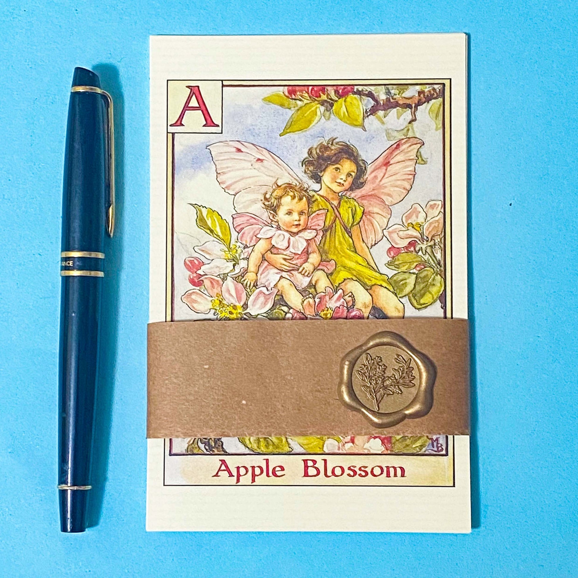 flower fairy postcard set wrapped in a kraft belly band with a wax seal on a blue background