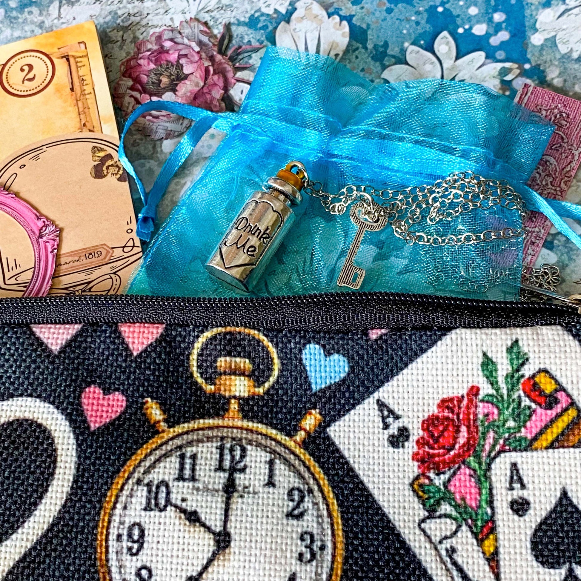 alice in wonderland time for tea stationery letterbox gift with canvas pouch, silver drink me necklace, book of clear vintage stickers and scrapbooking paper sheets