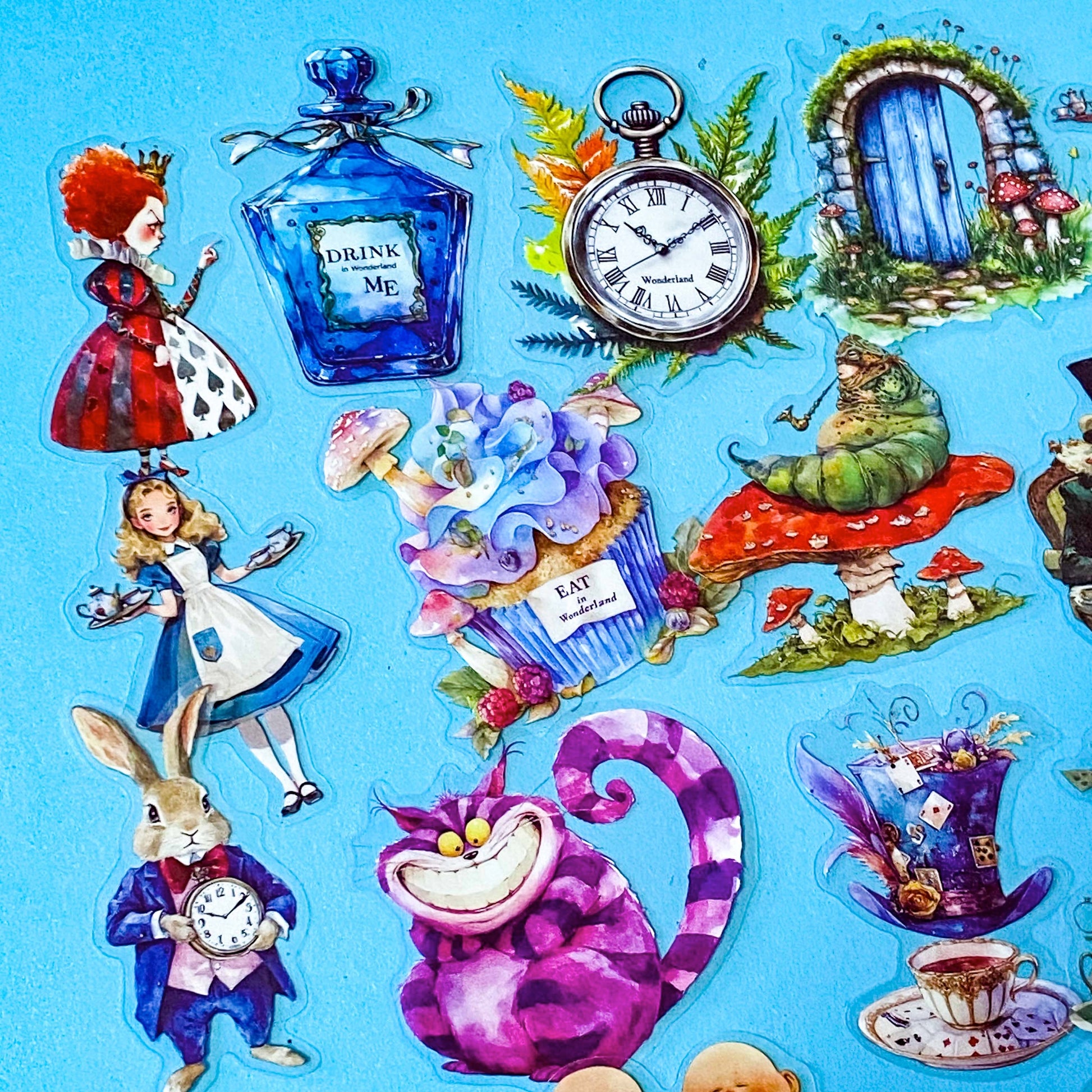 vibrant alice in wonderland plastic sticker set with 40 large PET stickers including Drink me potion, eat me cake, forest door, caterpillar on mushroom, the white rabbit, top hat, tea cups, red queen and pocket watch 