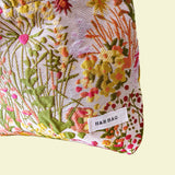 wildflower meadow tapestry pouch with colourful woven floral design including daisies, cream lining, concealed zip closure and gusseted base. Cream, orange, lemon, soft green and white design. Subtle sheen. Large cosmetic bag or toiletry pouch. Uk botanical gift shop.