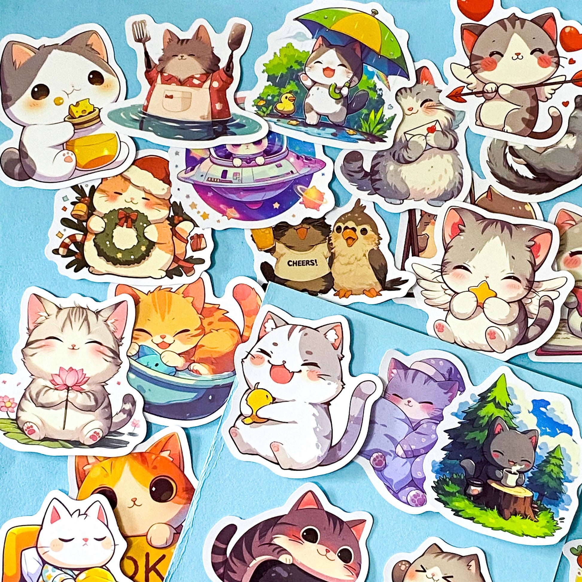 kawaii cat adventure laptop stickers pack with 50 colourful cute cartoon cat stickers on a blue background