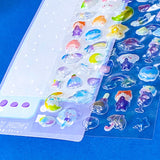 close up of plastic domed 3d stickers with cute rainbows, clouds, food and stars