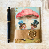 vintage mushroom postcard set wrapped in kraft belly band with a wax seal sticker featuring children dancing under a toadstool