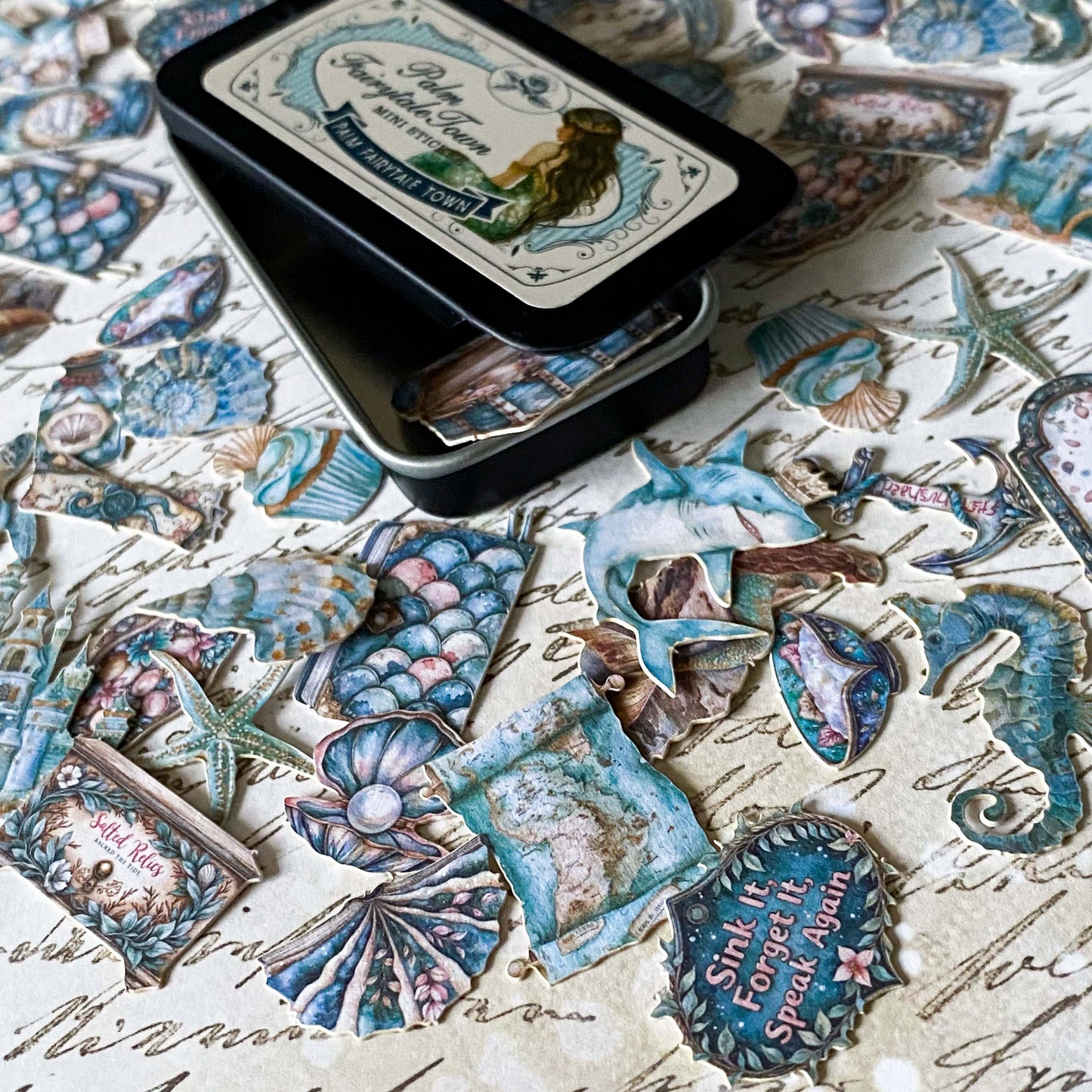 tiny scrapbook stickers in a mini travel tin with mermaid theme stickers