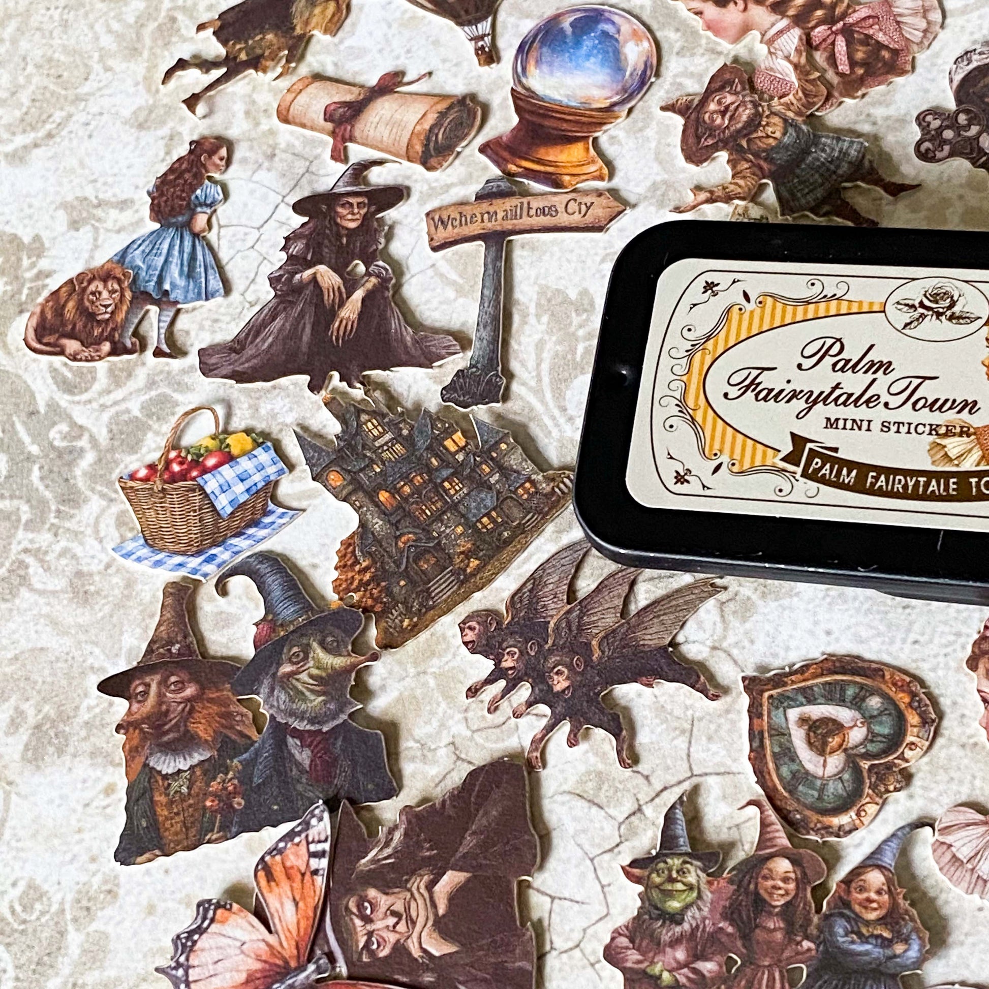 wizard of Oz card stickers in a mini tin featuring vintage style illustrations of dorothy, the lion, tin man and witch