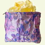 lavender, pink and gold satin tapestry pouch with woven floral design, cream lining, concealed zip and structured gusset base. Pastel large cosmetic bag or jewellery pouch. Journaling storage or travel essentials case. Uk gift shop for letterbox gifts.