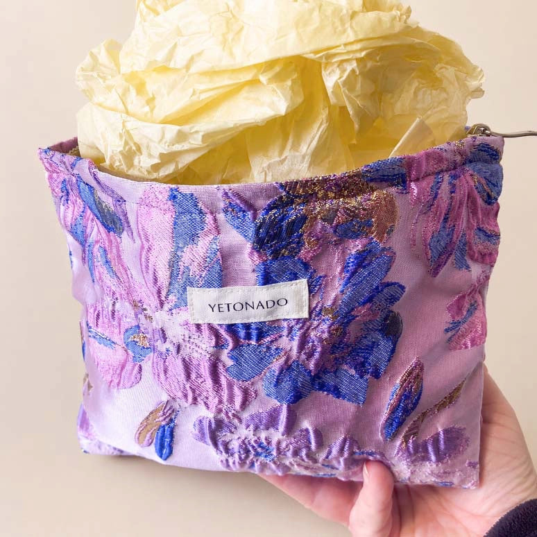 Elegant satin-finish tapestry pouch featuring woven lavender and blue florals with gold metallic thread, cream lining, concealed zip and gusseted base. Ideal for cosmetics and stationery