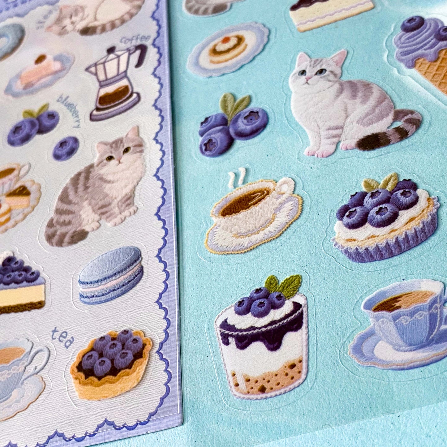 2 clear PET sticker sheets in a blueberry treats theme with grey tabby cats and decorative food and drink stickers with a blue theme. Uk cute stationery shop.