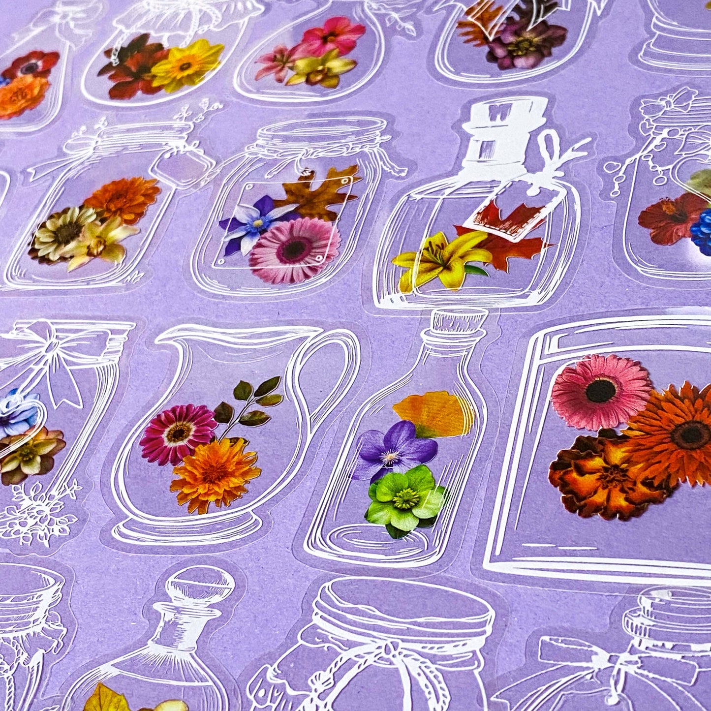  flowers stickers in clear jars and vases on a purple background