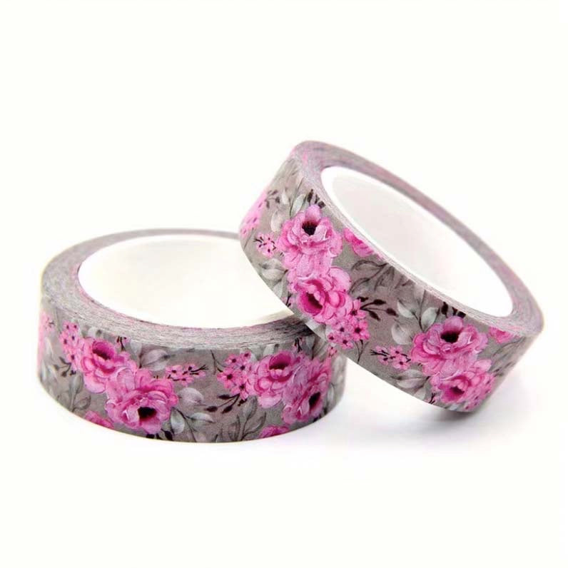 washi tape rolls with a pink  floral pattern on a grey background