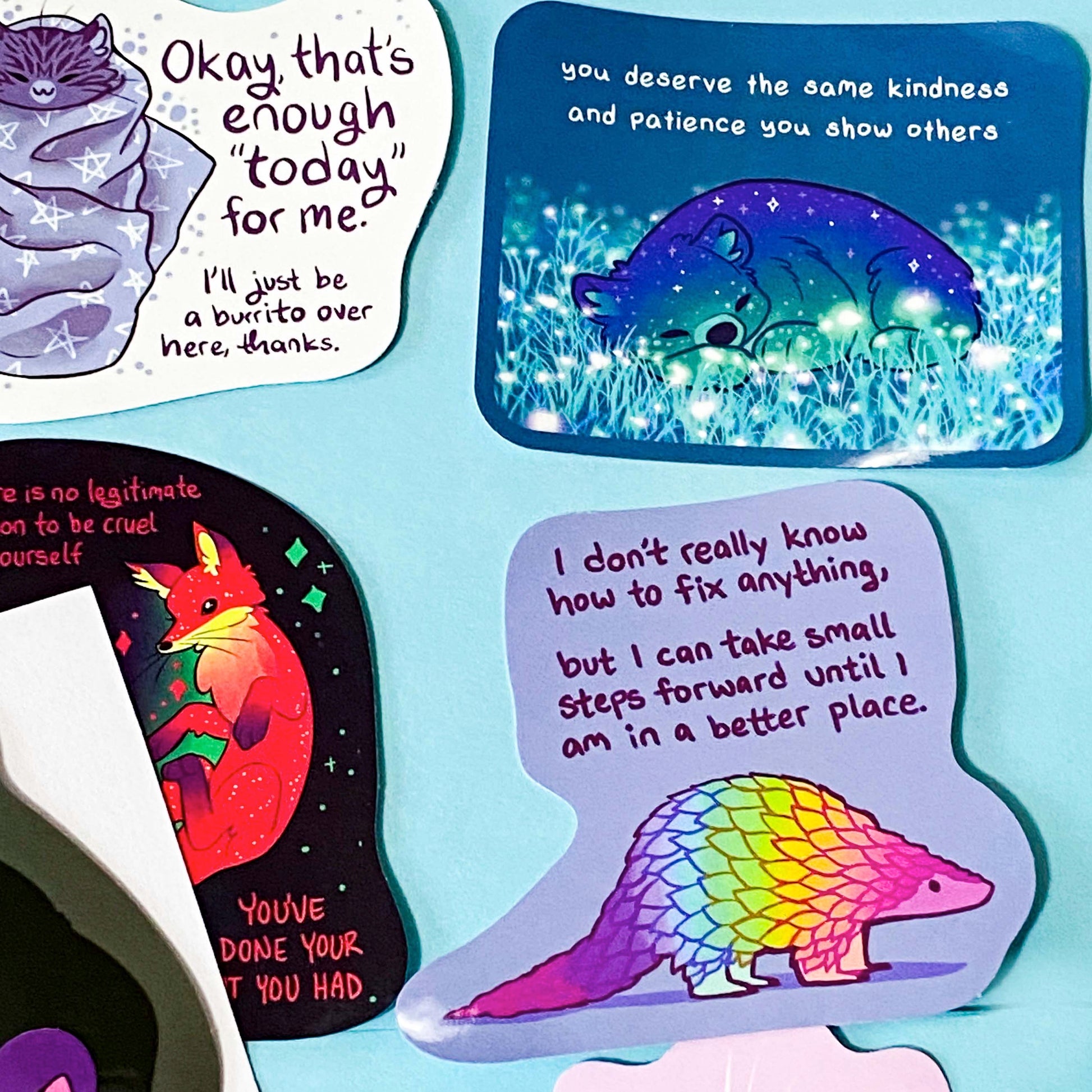 colourful glossy affirmation stickers with cute animals and positive mental health messages including  bear, pangolin and fantasy creatures on pastel background