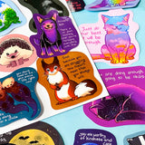 colourful glossy affirmation stickers with cute animals and positive mental health messages including foxes, cats and fantasy creatures on pastel background