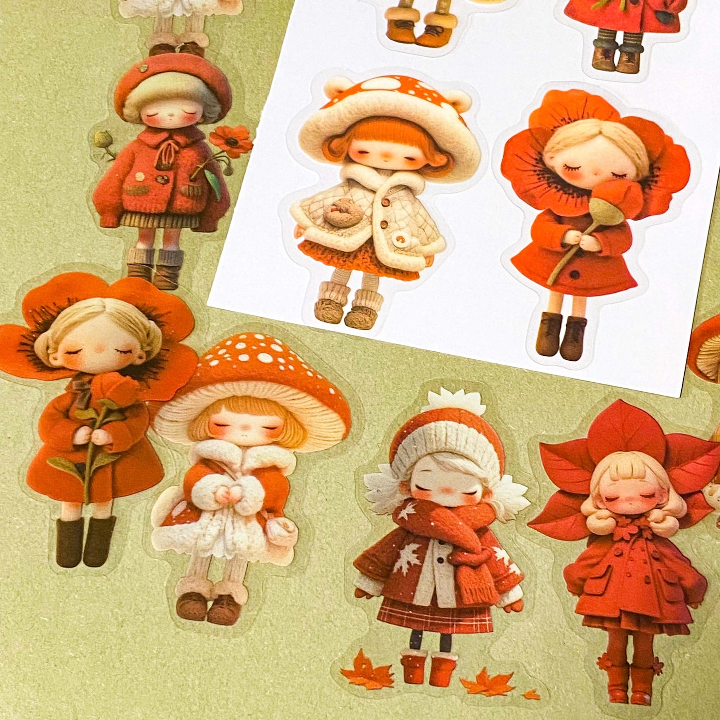 bright vibrant red doll stickers pack of 20 with colourful girls in cute outfits. Designs include a mushroom, poppies, flower petals and winter cosy outfits. uk stationery shop for kawaii gifts.