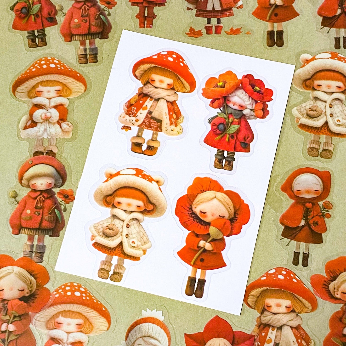bright vibrant red doll stickers pack of 20 with colourful girls in cute outfits. Designs include a mushroom, poppies, flower petals and winter cosy outfits. uk stationery shop for kawaii gifts.