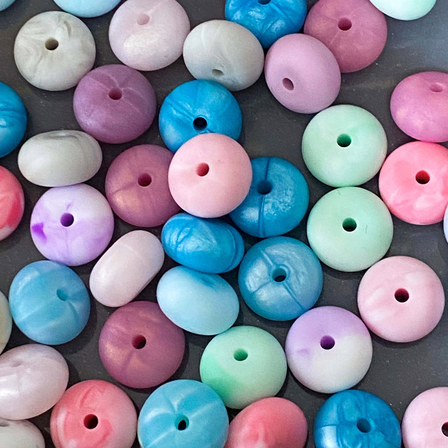 silicone spacer beads with a chunky shape and  marble and pearl finish in pink, blue, mint, rose, metallic blue and purple.