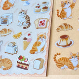 two assorted clear PET sticker sheets featuring ginger cats with bakery treats, pastries, cakes and cosy dessert illustrations. uk planner supplies shop