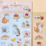 two assorted clear PET sticker sheets featuring ginger cats with bakery treats, pastries, cakes and cosy dessert illustrations. uk planner supplies shop