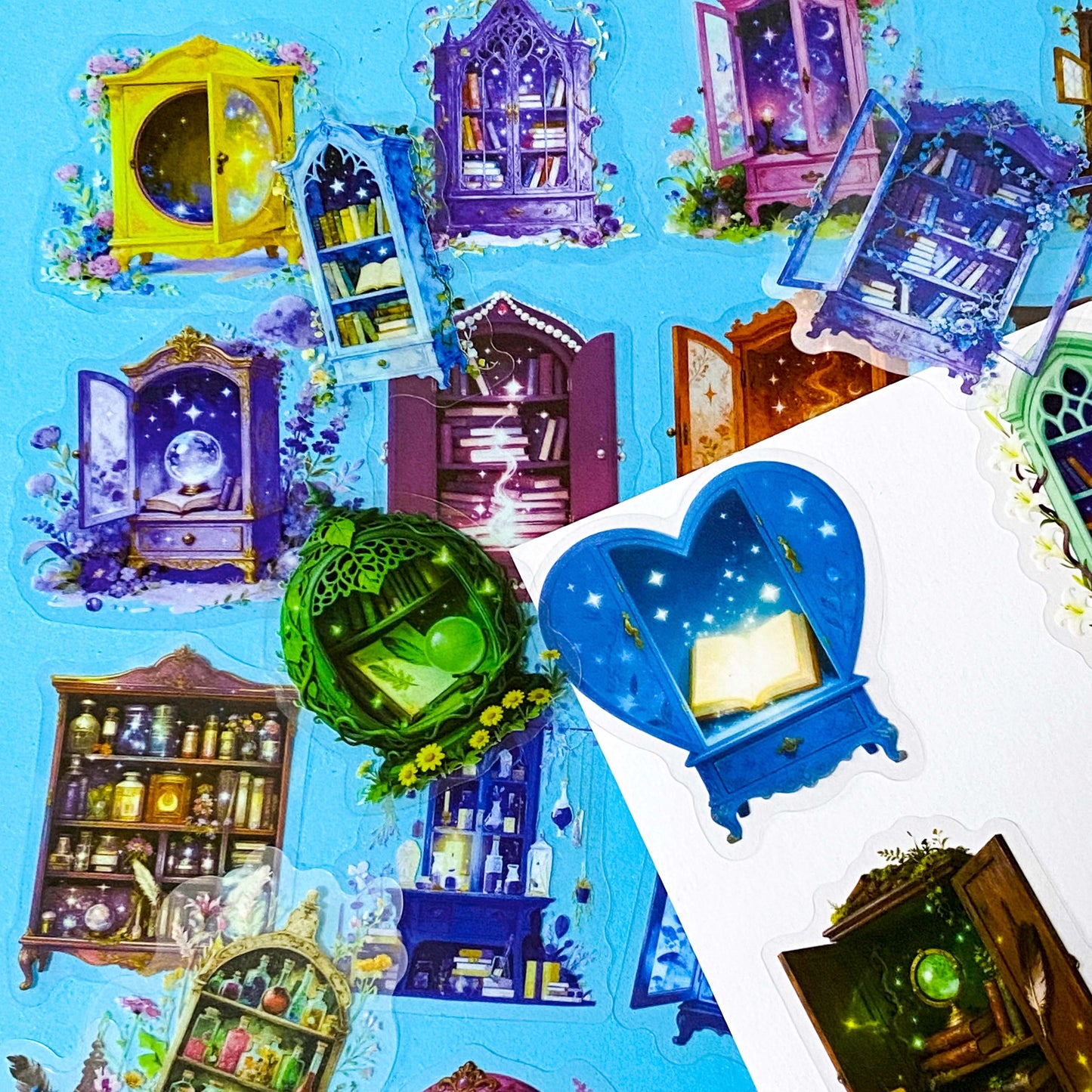 fantasy plastic sticker set featuring magical cabinets, glowing bookshelves, potion cupboards and celestial library illustrations in blue, purple and green tones. UK cute stationery, sticker shop.