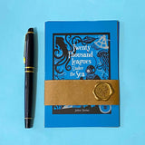 set of 4 vintage literary postcards featuring class adventure stories including twenty thousand leagues under the sea, wrapped in a kraft belly band with a wax seal sticker