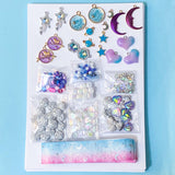 craft bundle with a space theme celestial with enamel charms, beads, sequins, grosgrain ribbon and flatbacks on a blue background