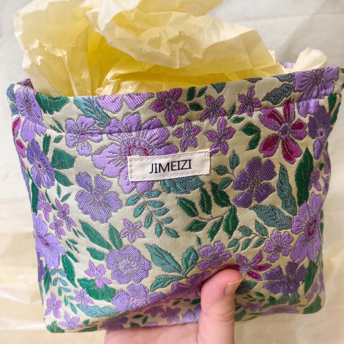 lilac cottage garden tapestry pouch with woven floral fabric in shades of lavender, purple, turquoise and green, fully lined with concealed zip fastening. Uk letterbox gifts. Beautiful quality cosmetic bags.