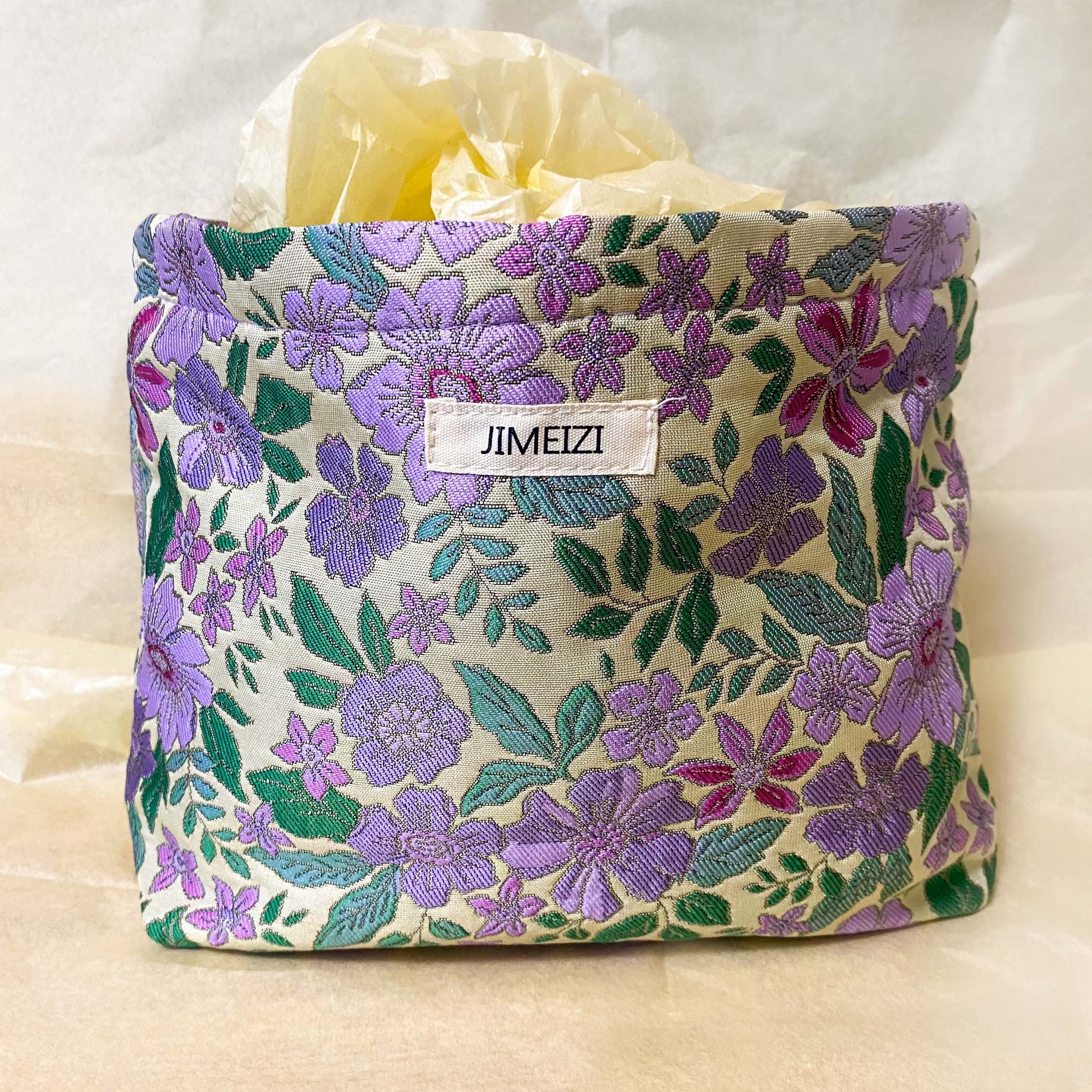 lilac cottage garden tapestry pouch with woven floral fabric in shades of lavender, purple, turquoise and green, fully lined with concealed zip fastening. Uk letterbox gifts. Beautiful quality cosmetic bags.