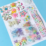 craft bundle with a kawaii cute pastel theme with beads, flatbacks, enamel charms, sequins and ribbon on a blue background