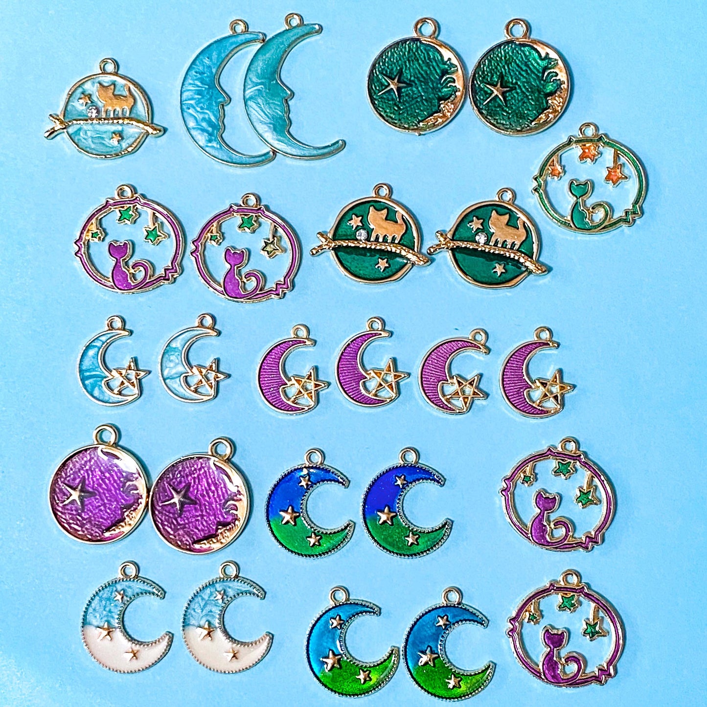 space themed enamel charm bundle with 26 gold tone charms of planets, stars and moons