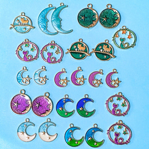 space themed enamel charm bundle with 26 gold tone charms of planets, stars and moons