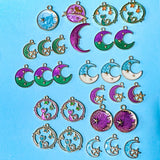 space themed enamel charm bundle with 26 gold tone charms of planets, stars and moons