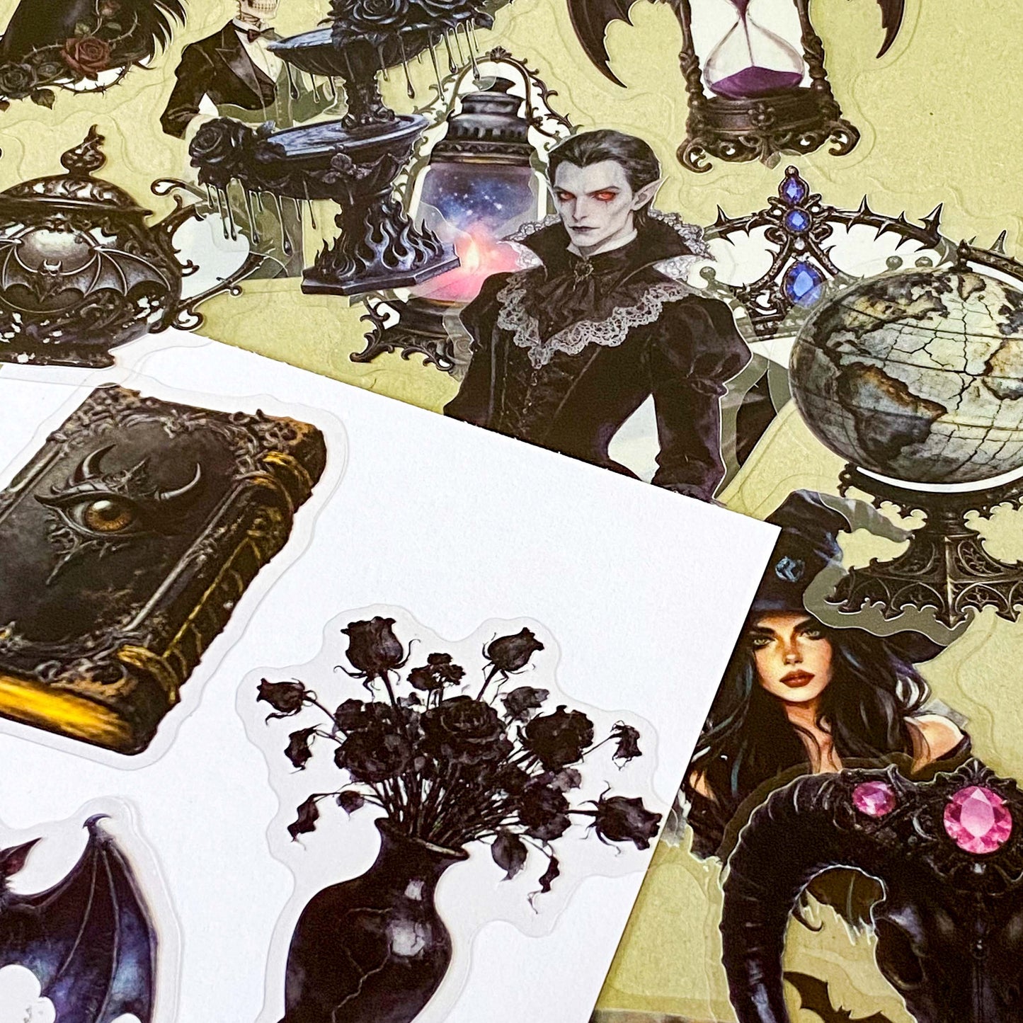 pack of 50 gothic PET stickers featuring ravens, dragons, black cats, antique books, potion bottles, crystals, witches, bats and dark academia stickers. black aesthetic. uk stationery shop.