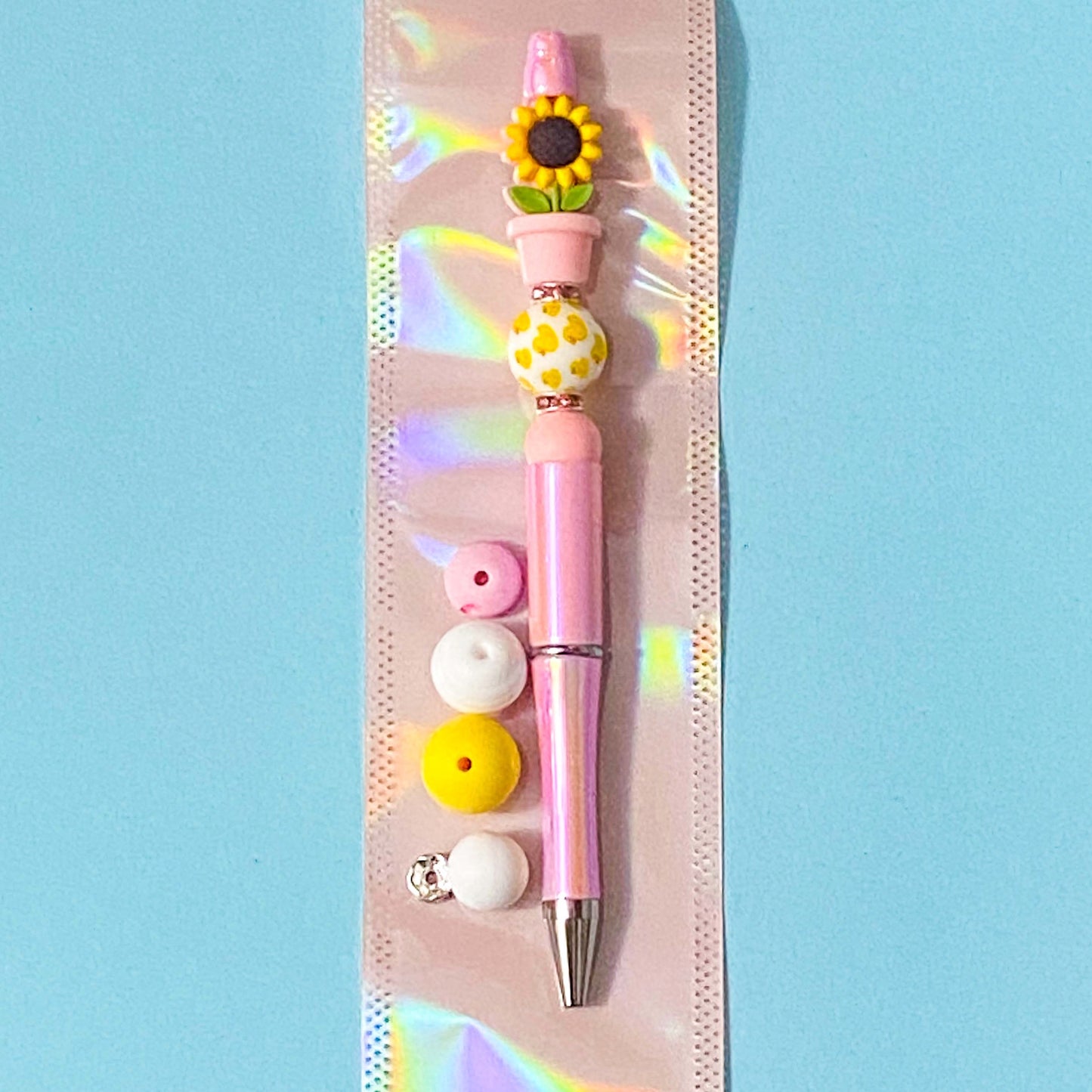 sunflower in pink pot silicone beads diy beading pen kit on a blue background