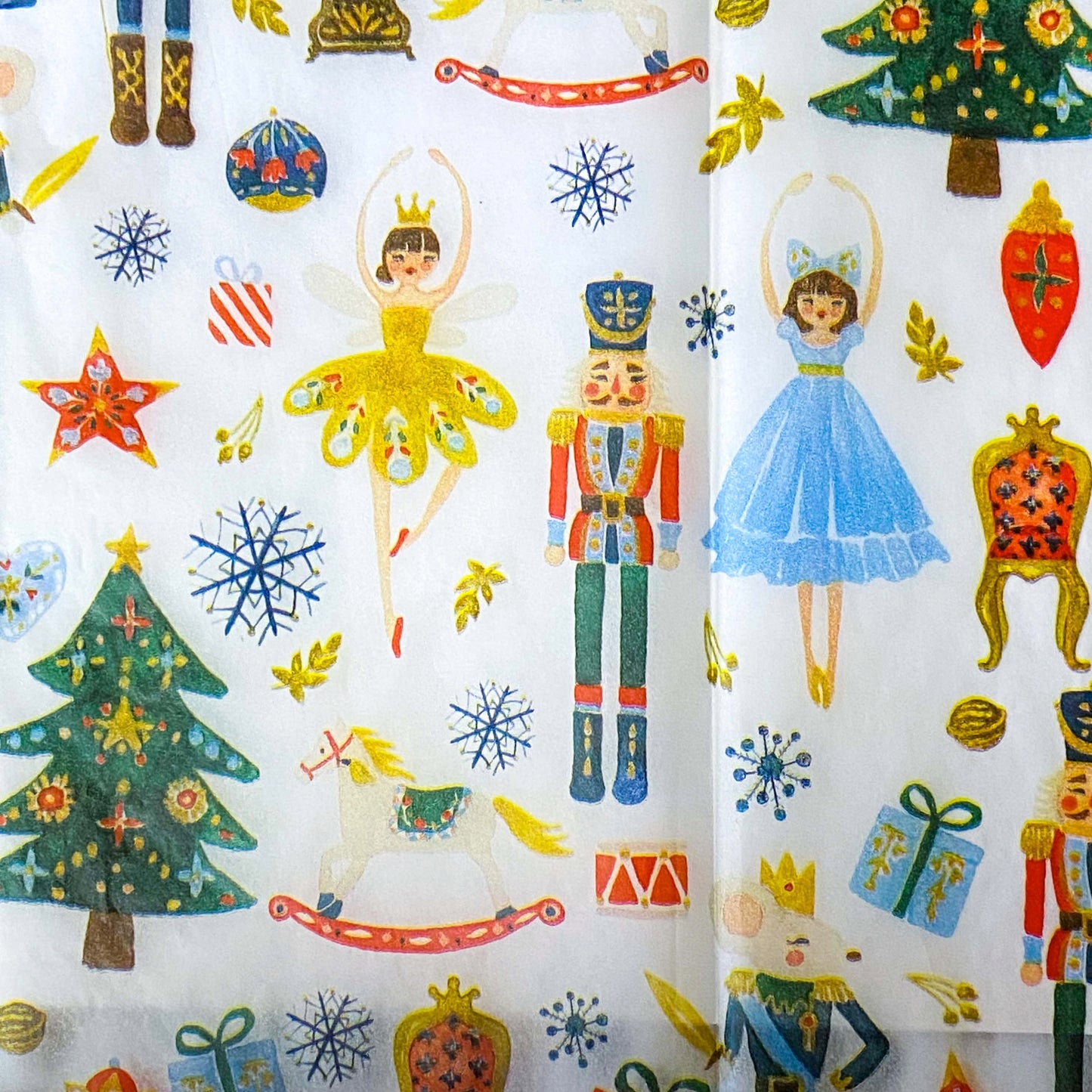 nutcracker suite christmas tissue paper wrap with clara, the sugar plum fairy, toys and the mouse king on a white background.