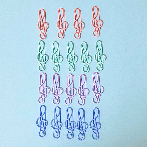 Colourful treble clef musical paper clips arranged in a grid on a light blue background