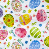 Colourful tissue paper sheets with a pattern of Easter eggs and flowers on a white background