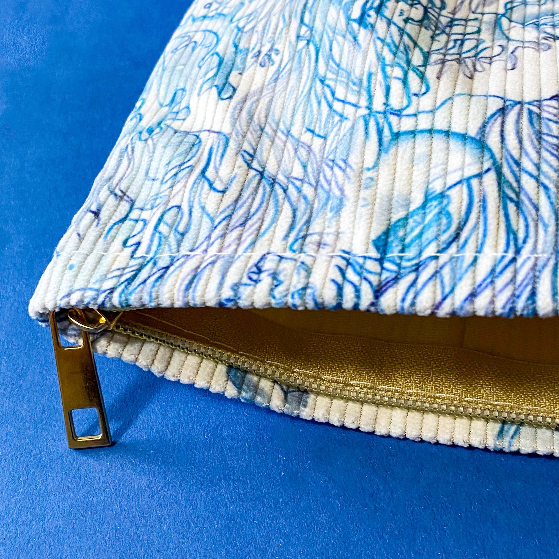 white and pale blue corduroy zip pouch with an underwater illustration featuring sea turtles, fish, marine plants. It is fully lined with waterproof fabric and finished with a sturdy metal zip. uk letterbox gift shop.