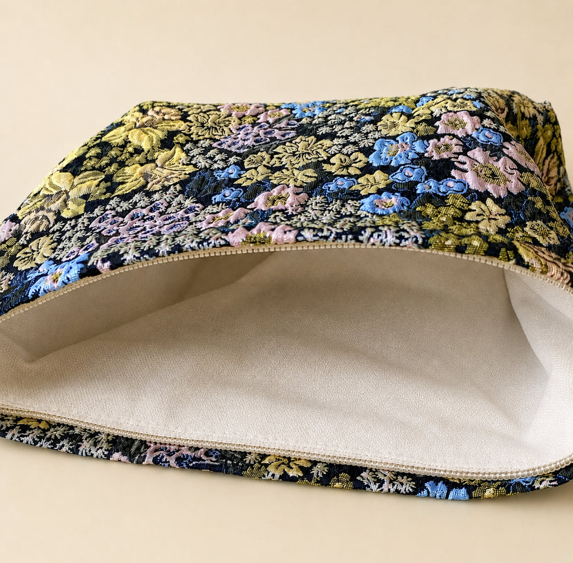 beautiful woven floral tapestry pouch with cream lining, concealed zip- finish and gusseted base. English garden at twilight themed pattern with daffodils, foxgloves, blue pink and yellow flowers. Perfect for cosmetics, stationery and everyday essentials.
